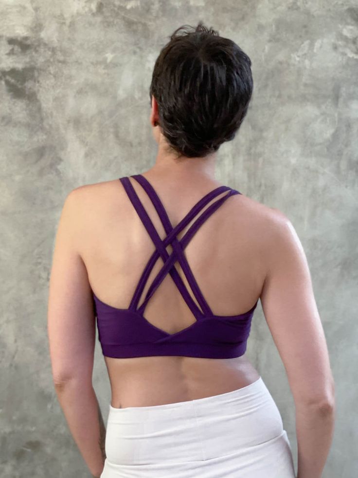 Designed to layer under our tops and tunics, this bra top brings comfort, flare, support, and style. The gently sloping neckline has added spaghetti straps that cinch to an eye-hole front, and a cross-braided back. Wear it for your practice with leggings or take it out dancing under some of our cowl neck tops. It provides great coverage and is both comfortable and supportive for activities like dance and yoga. Criss Cross Bra, Eye Hole, Jersey Tops, Cowl Neck Top, Yoga Bra, Draped Fabric, Bra Top, Bra Tops, Cowl Neck