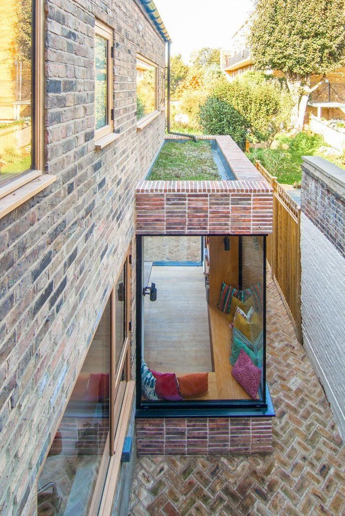 the house is made out of bricks and has an open floor plan that allows for easy access to the backyard