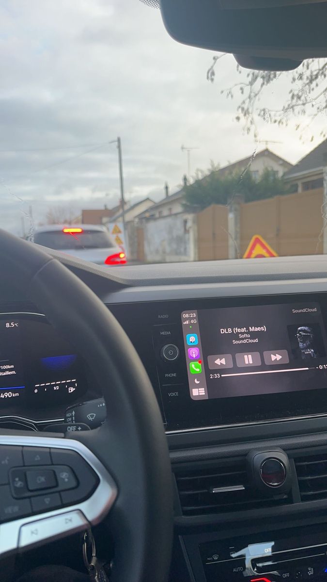 the dashboard of a car with an electronic device in it's center console, along with other vehicles