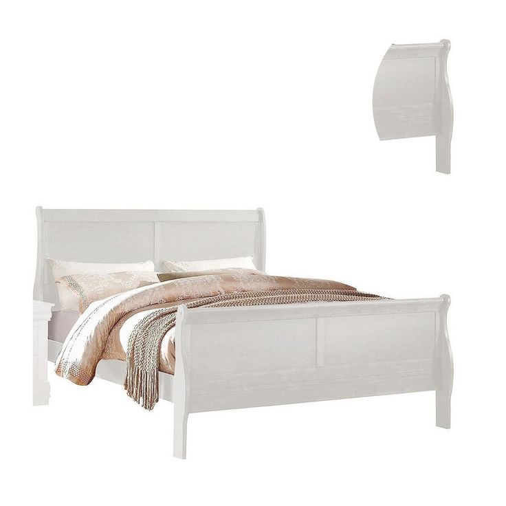 a white bed sitting next to a night stand with two pillows on top of it