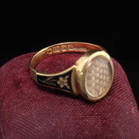 Beautiful Antique Victorian 18K Yellow Gold Enamel Hair Mourning Ring. This amazing ring has pristine enameling and the hair is still intact inside the glass. It has flower designs on the side of the ring without any damage which is rare. The inside of the ring is hallmarked.Item #R0926Metal: 18K Yellow Gold.Weight: 4 GramsRing Size: 8Measurements: Top measures 13 mm wide and band measures 2.8 mm wide.Measurement from finger to top of ring: 3.75  mmLayaway: For your convenience, we will be happy Vintage Gold Enamel Ring Stamped 14k, Victorian Enamel Ring Engraved For Anniversary, Victorian Style Hallmarked Enamel Ring For Anniversary, Victorian Engraved Enamel Ring For Anniversary, Heirloom Oval Engraved Enamel Ring, Heirloom Engraved Oval Enamel Ring, Victorian Gold Enamel Ceremonial Ring, Victorian Yellow Gold Enamel Ring, Victorian Yellow Gold Enamel Ring For Anniversary