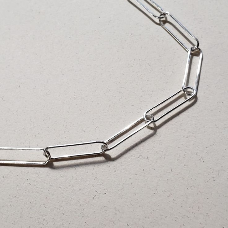 This is an image of a 20 sterling silver paperclip chain necklace by Jennifer Favour. This chain is long and lightweight and has a lobster clasp closure. Cable Chain Necklace, Fitness Bracelet, Ring Fit, Silver Chain Necklace, Minimalist Style, Paper Clip, Cable Chain, Ring Bracelet, Jewelry Care