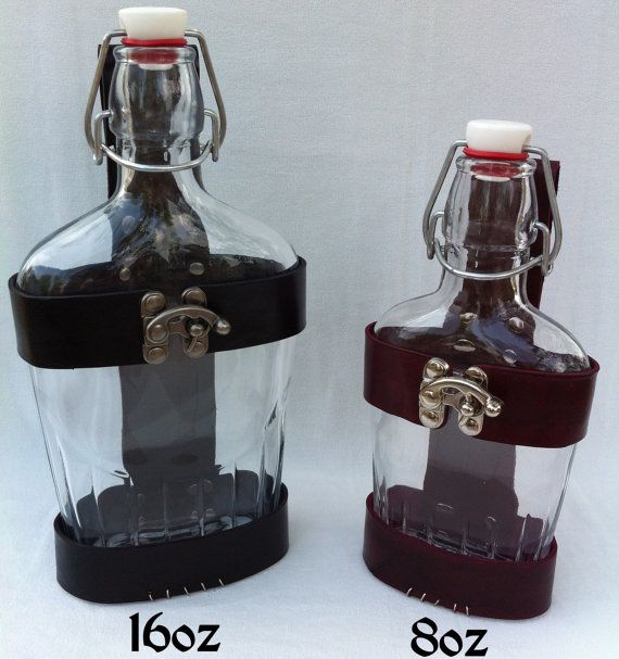 two glass bottles with metal handles are shown side by side