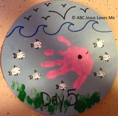 a paper plate with a handprinted image of a pink crab and fish on it