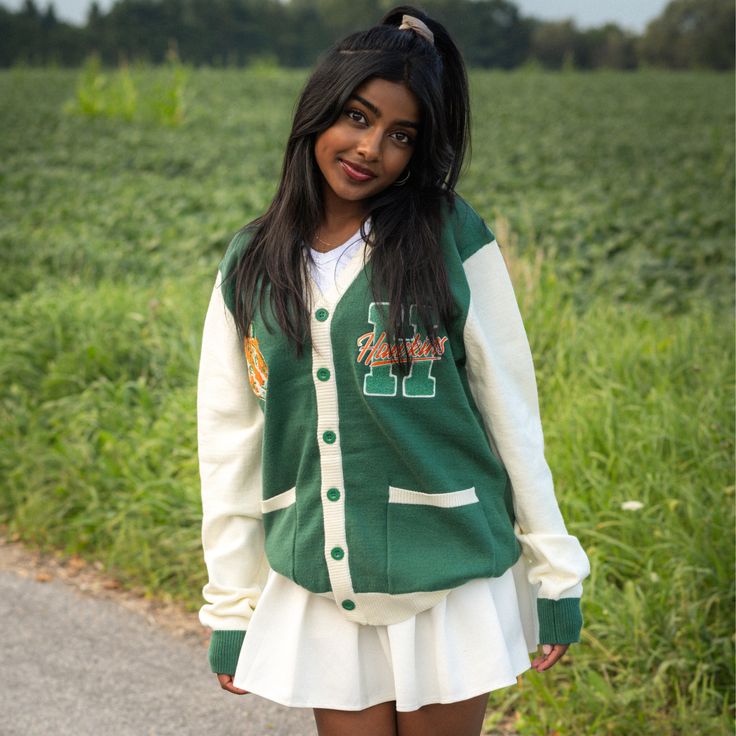 Show your Hawkins High School Pride by getting into uniform with our cozy knit cardigan featuring embroidered chenille patches. Go Tigers! 100% Acrylic Oversized Unisex Fit Embroidered Chenille Patches Stranger Things x Cakeworthy Licensed Product. Model Sizes: Male Model: Medium Female Model: Small Fall Collegiate Style College Cardigan, Collegiate Cardigan For College In Fall, Collegiate Fall Cardigan For College, Winter Varsity Cardigan, Varsity Cardigan For Winter College Season, Varsity Style Cardigan For College In Winter, Varsity Style Winter Cardigan For College, Collegiate Style Cardigan For Fall College Season, Collegiate Style Fall Cardigan For College