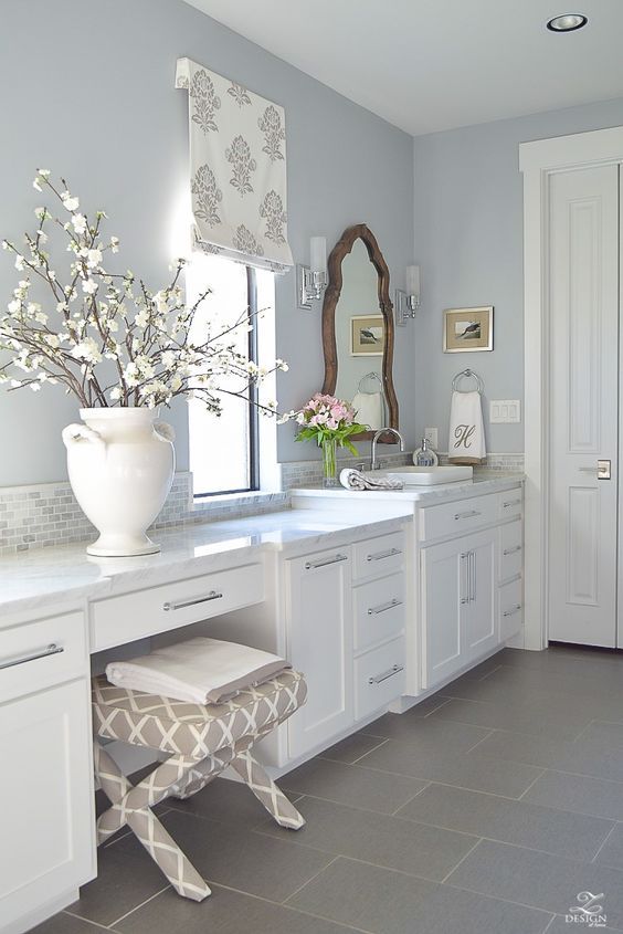 an image of a bathroom with white cabinets and gray flooring on the front page