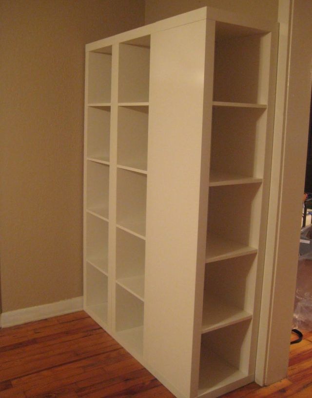 an empty bookcase in the corner of a room