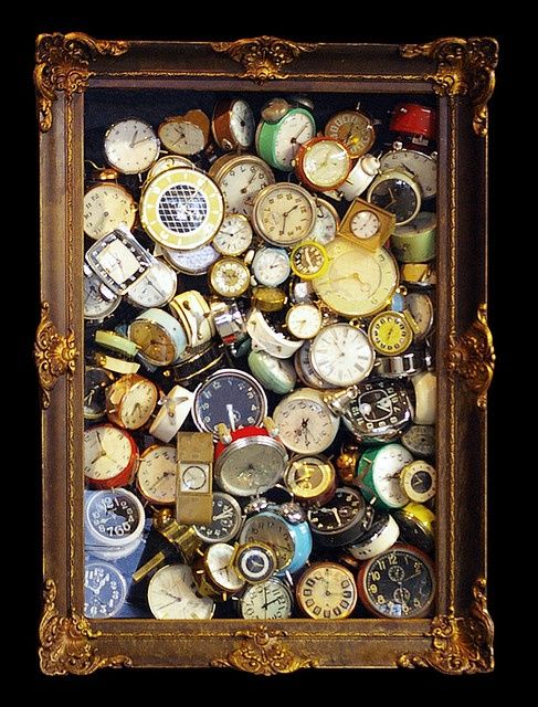 an old frame filled with lots of different types of clocks