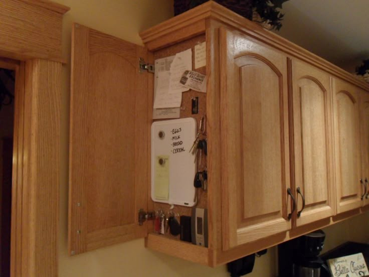 a kitchen with wooden cabinets and magnets on the wall