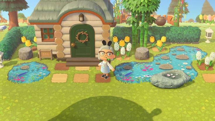 an animal crossing game with a person standing in front of a small house and pond