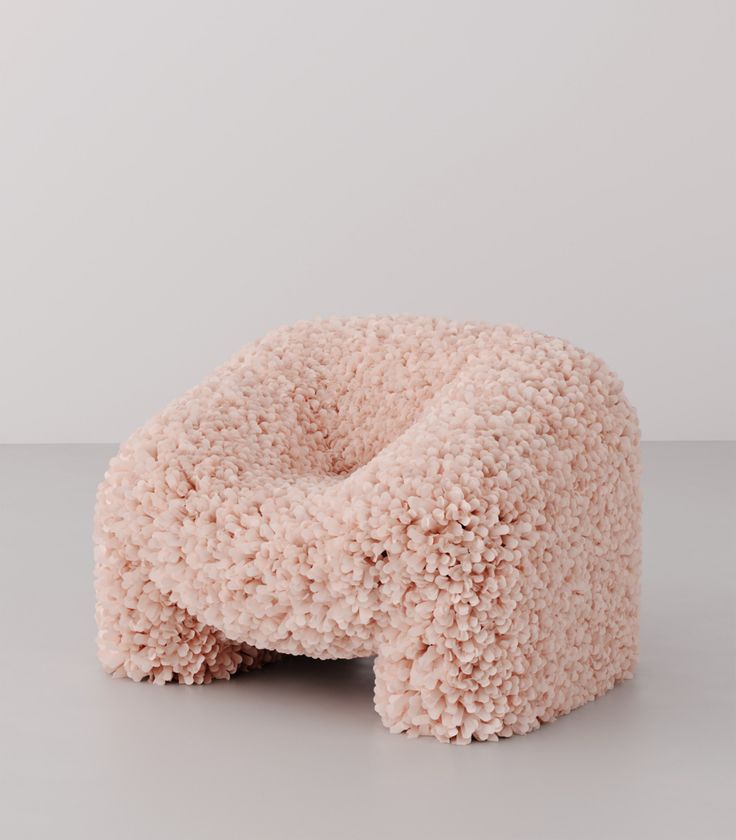 a pink chair that is shaped like a pillow