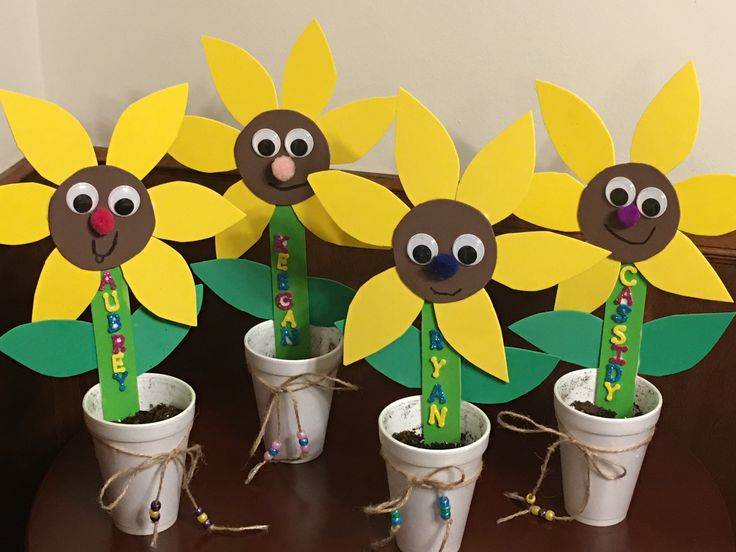 sunflowers are arranged in flower pots with markers on them