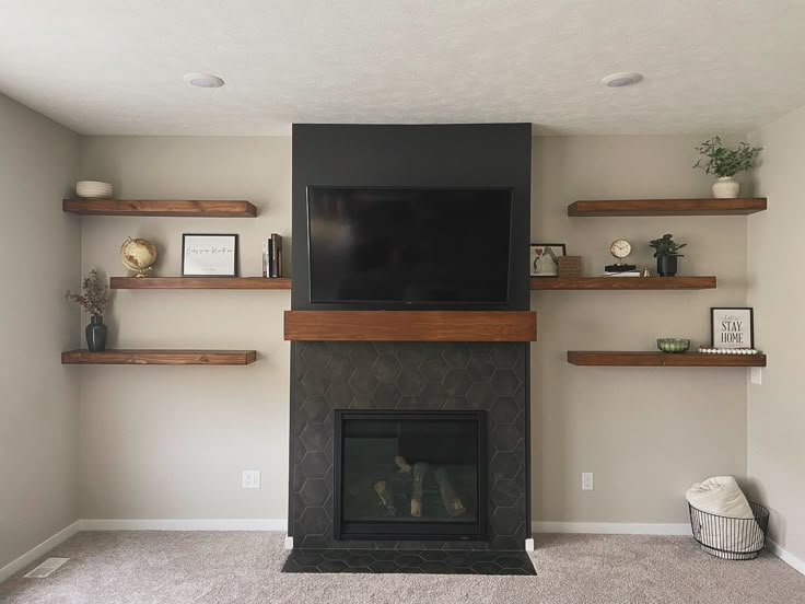 a living room with a fireplace and shelves on the wall, including a flat screen tv