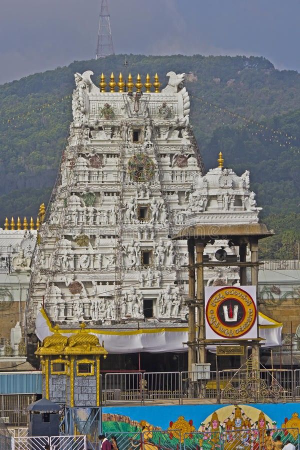 an ornate white temple in front of a mountain