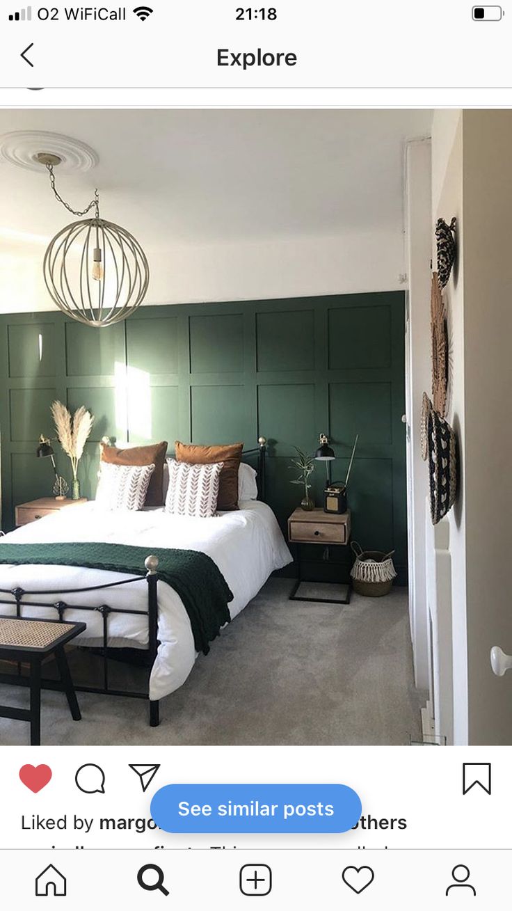 a bedroom with green walls and white bedding