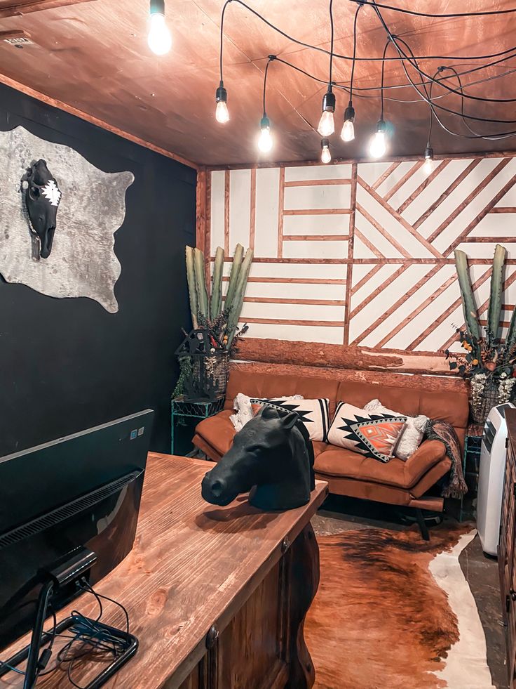 a living room filled with furniture and decor on top of a wooden table in front of a flat screen tv