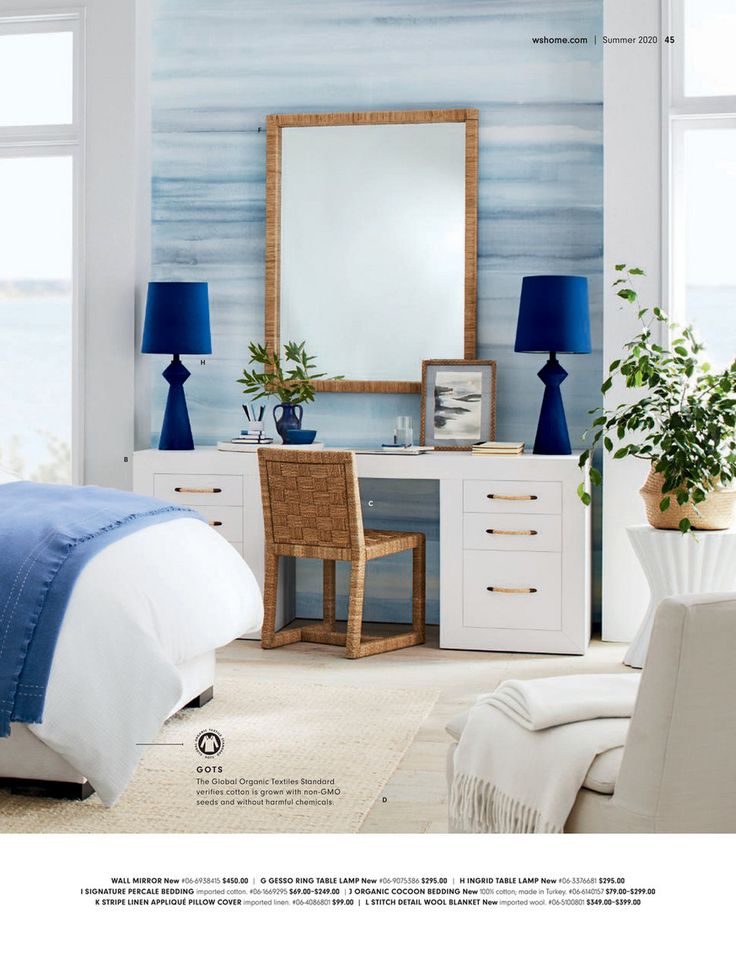 a bedroom with white furniture and blue accents