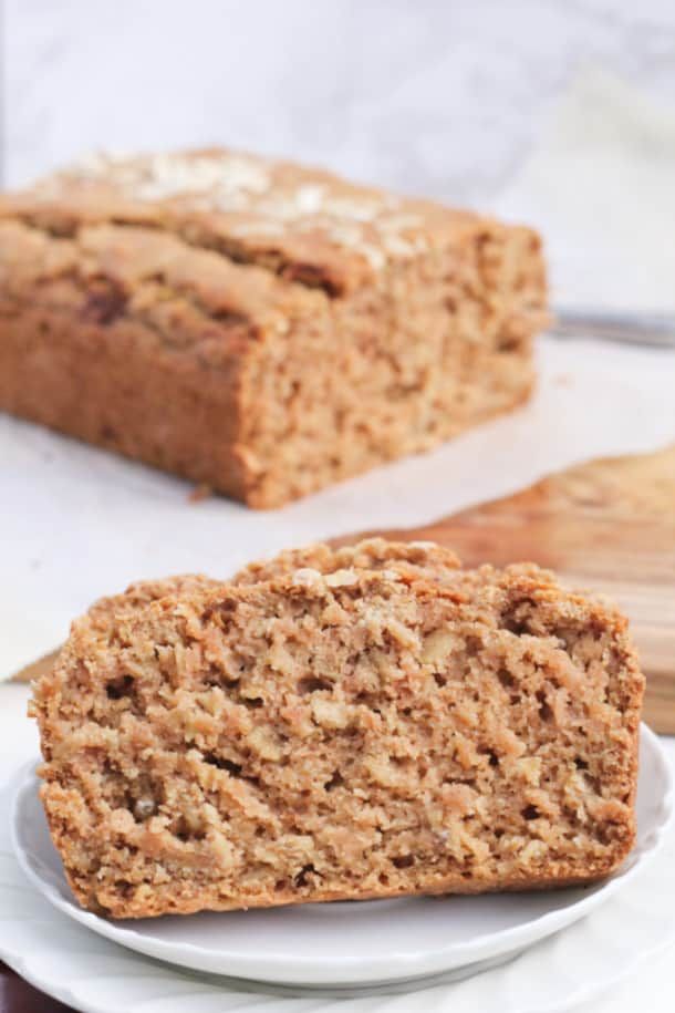 two slices of banana bread sitting on top of a white plate next to each other