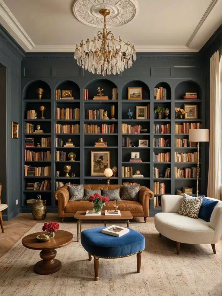 a living room filled with lots of furniture and bookshelves covered in shelves full of books