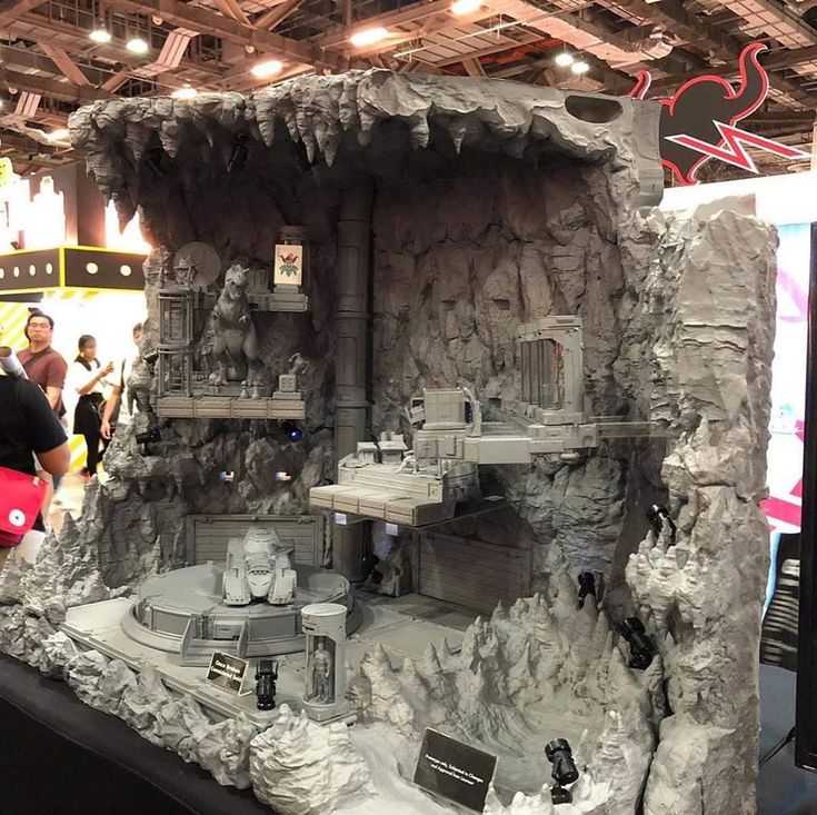 a model of a house made out of rocks and other items on display at a convention