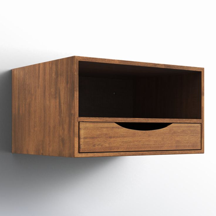 a wooden shelf with a drawer on the side and a white wall in the background