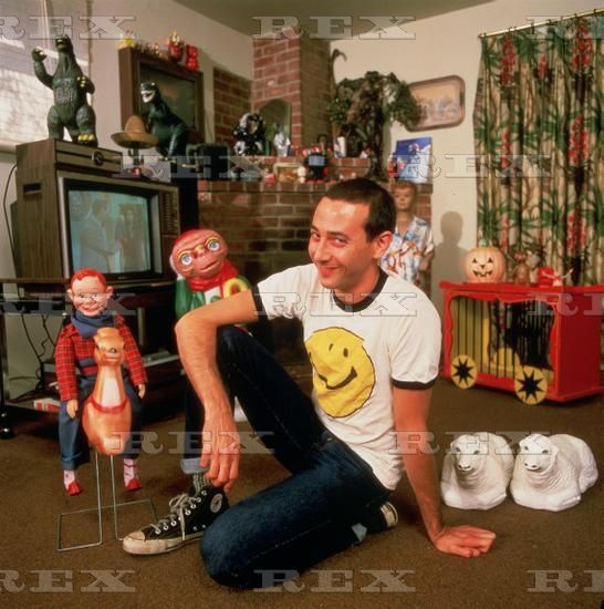 a man sitting on the floor in front of toys