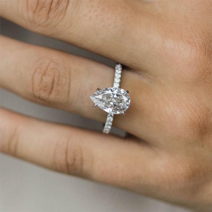 a woman's hand with a diamond ring on it