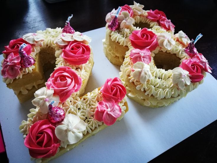 two pieces of cake with pink and white frosting