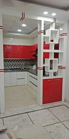 a kitchen with red and white cabinets in the middle of it's remodel