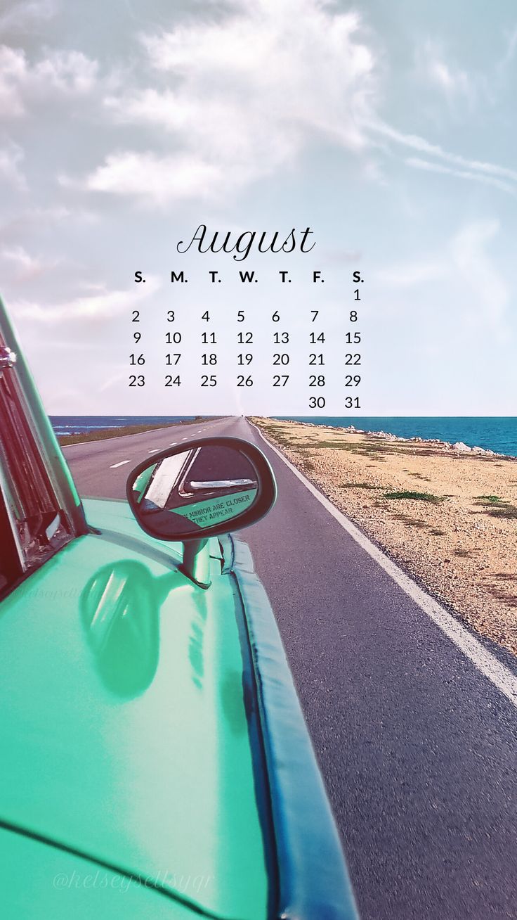 a green truck driving down a road next to the ocean with a calendar on it's side