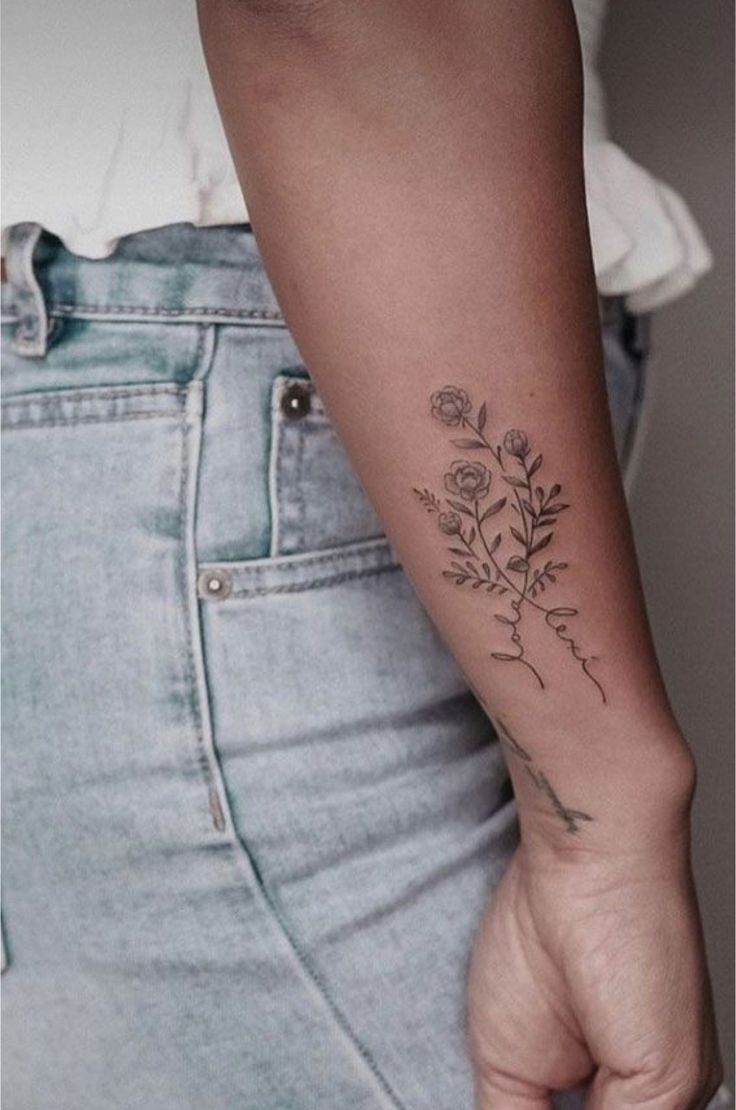 a woman with a flower tattoo on her arm