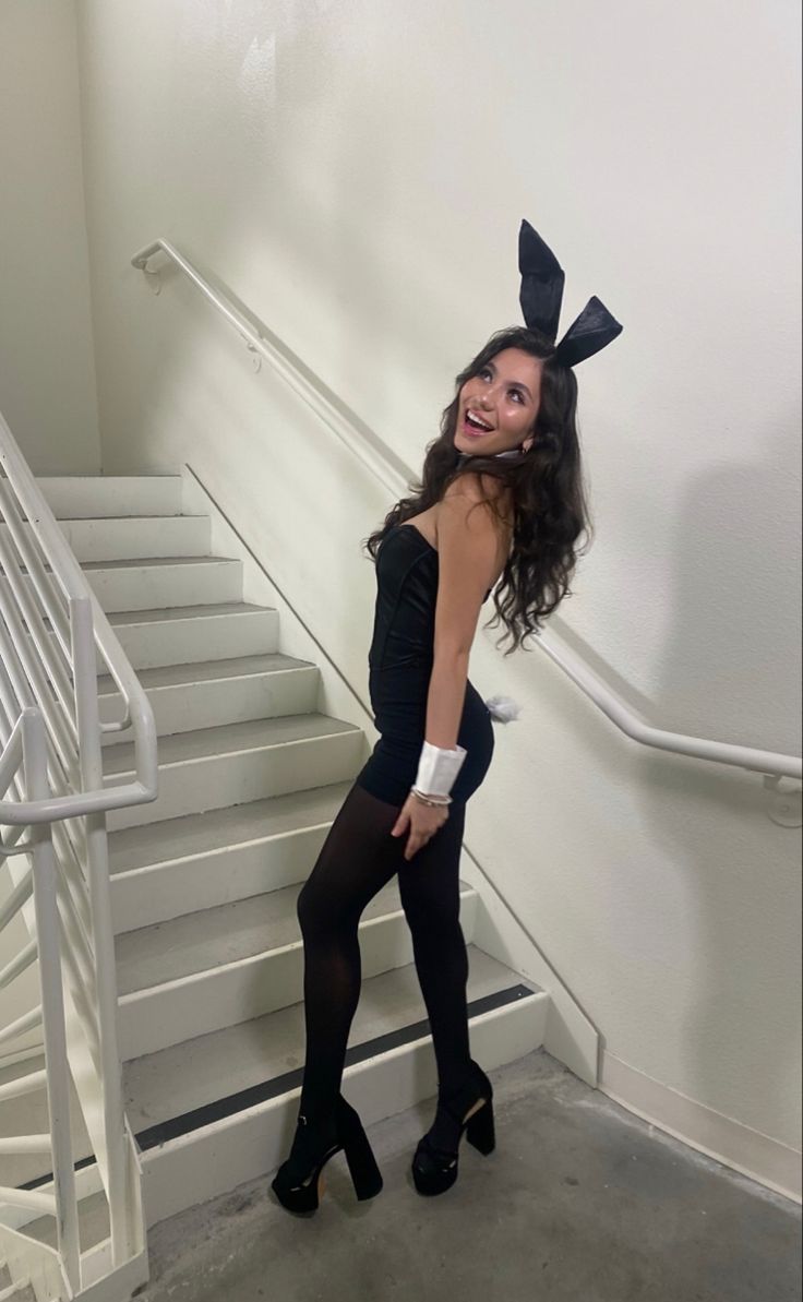 a woman in bunny ears is posing for the camera