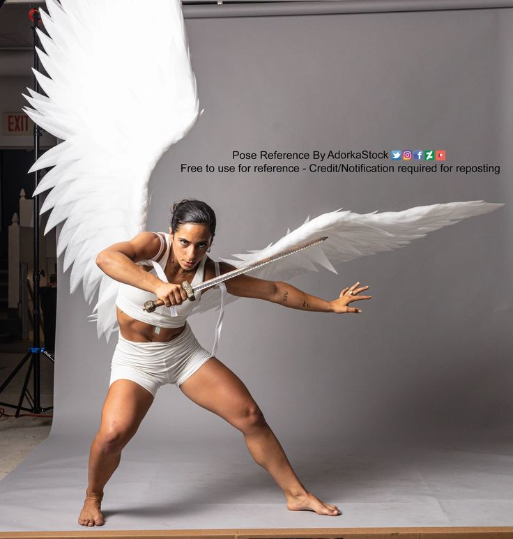 a woman with white wings is posing for a photo