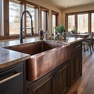 a kitchen with wooden floors and large windows next to a sink in front of a window