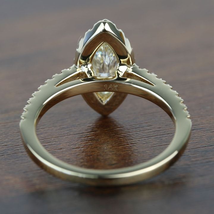 a close up of a ring on a table with a wooden surface in the background