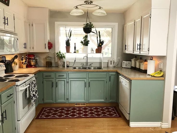 the kitchen is clean and ready for us to use it's green cabinetry