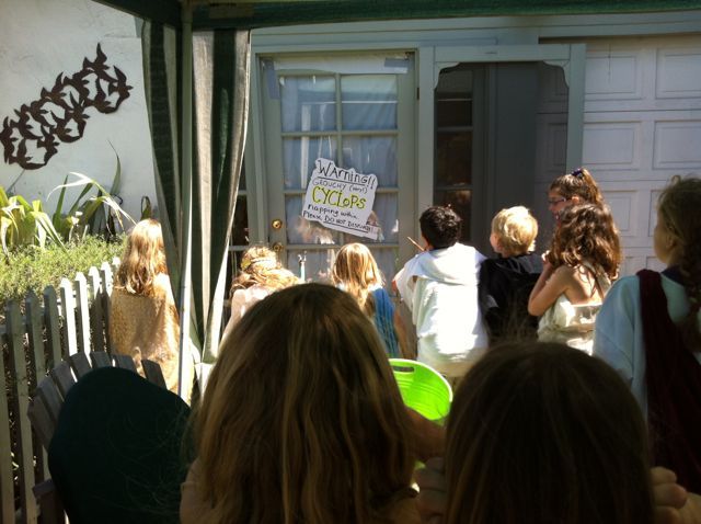 a group of people standing in front of a house with a green frisbee