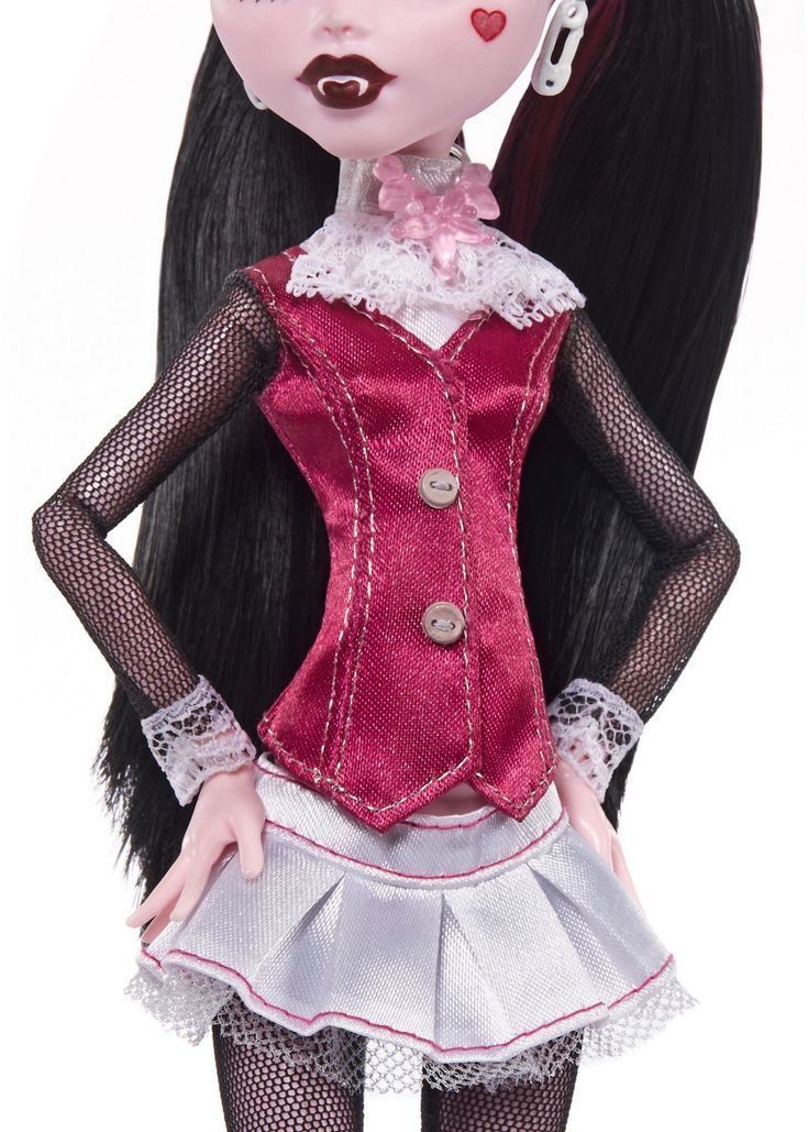 a doll with long black hair wearing a red dress