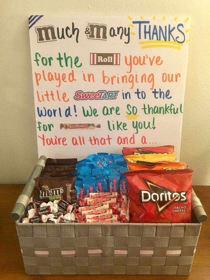 a basket filled with candy and candies next to a sign that says thank you