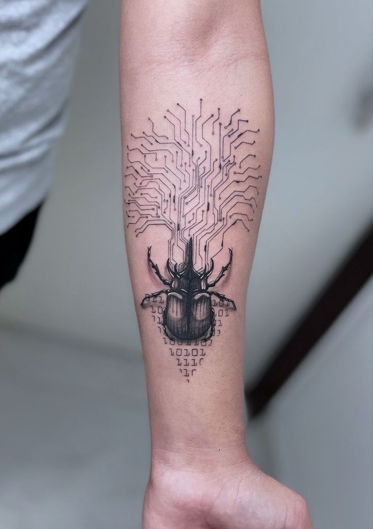 a person's arm with an electronic bug tattoo on the left side of their arm