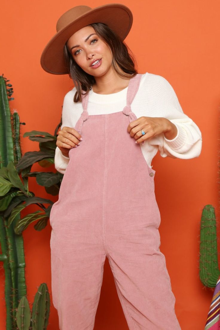 This cute corduroy jumpsuit is so soft and comfy. It features side pockets, button sides, straight legs, and knotted straps. This jumpsuit looks great paired with one of our long sleeve sweaters. Dusty Pink Color Fits true to size Made in the USA Fall Cotton Overalls For Loungewear, Trendy Cotton Overalls For Loungewear, Casual Pink Jumpsuits And Rompers For Fall, Casual Corduroy Overalls For Fall, Casual Fall Corduroy Overalls, Casual Pink Overall Shortalls, Casual Pink Shortalls, Casual Pink Cotton Shortalls, Pink Cotton Casual Shortalls