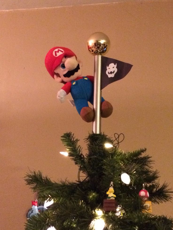 a christmas tree decorated with mario and his pirate flag, is shown in this image