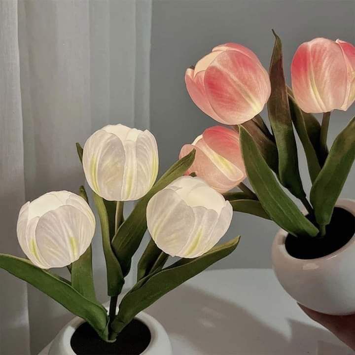 three white vases with pink flowers in them