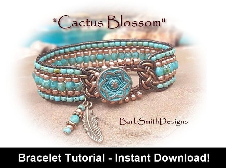 a bracelet with turquoise beads and an arrow charm on it, sitting in the sand