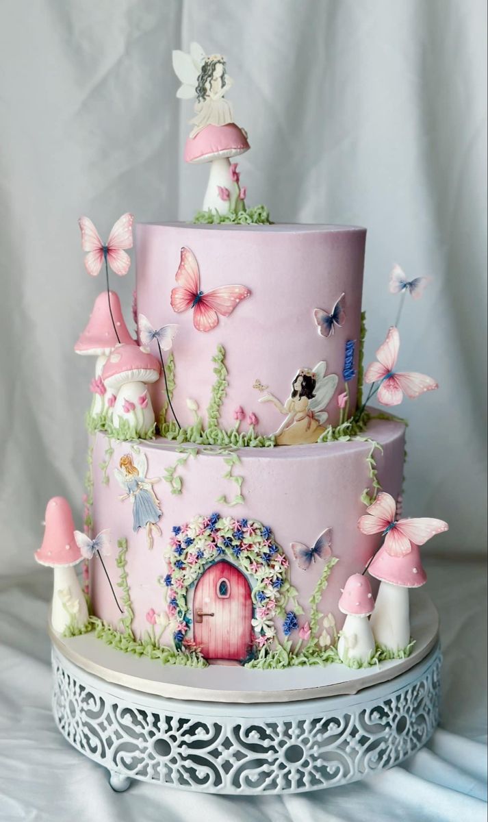 a three tiered cake with pink frosting and butterflies on the top, sitting on a white platter