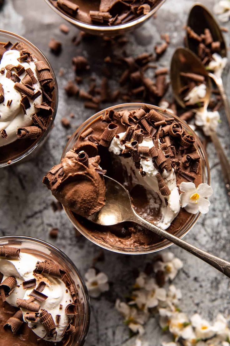 three dessert dishes with chocolate pudding and whipped cream