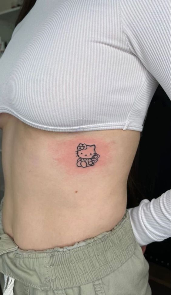 a woman with a hello kitty tattoo on her stomach