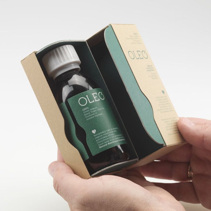 a hand holding an open box with a bottle in it that says oleec on the inside