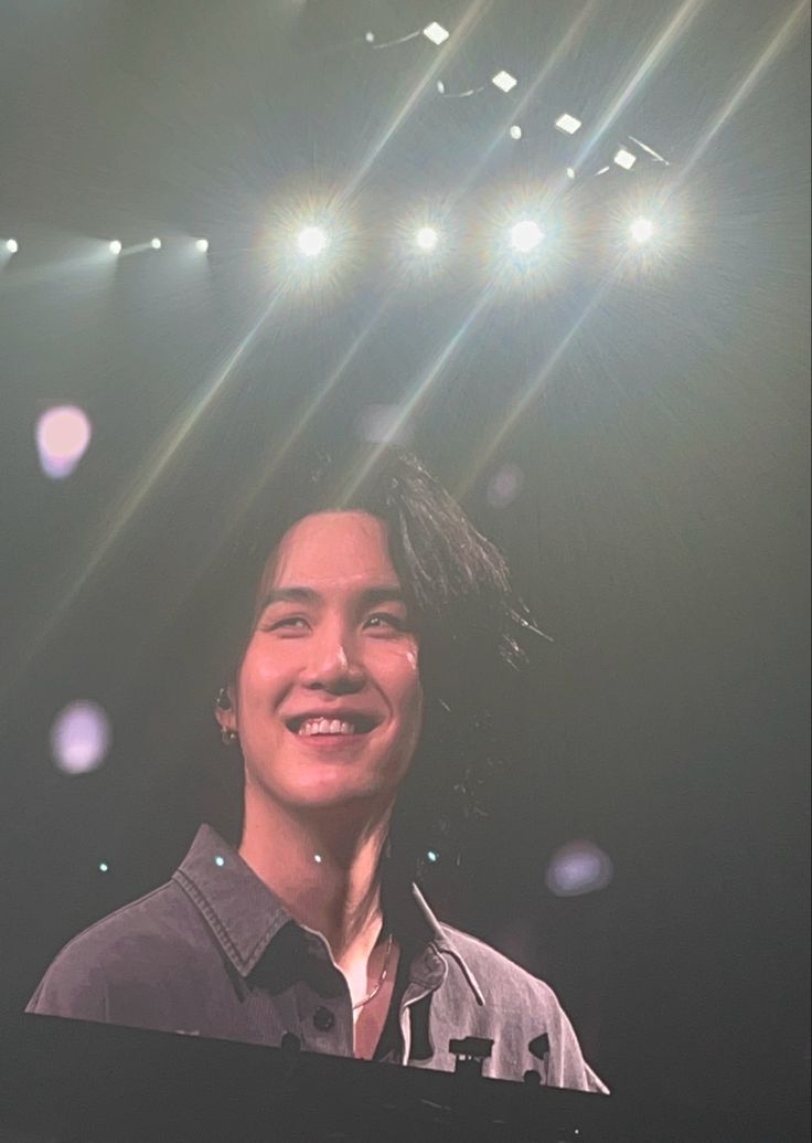 a man standing in front of a stage with lights