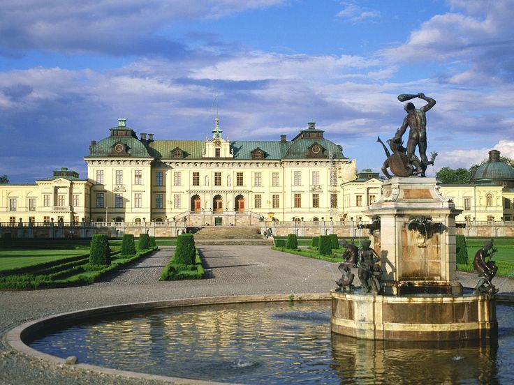 a large building with a fountain in front of it